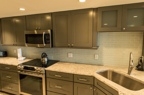 Bianco Romano Granite with Gray Glass Subway Tiles and Storm Gray Kitchen Cabinets